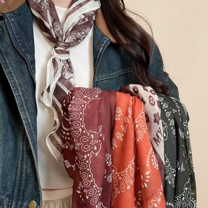 Detail of assorted printed silk scarves showing various floral and geometric patterns