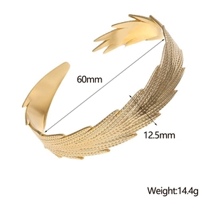 Detail shot of gold feather cuff bracelet showing dimensions 60mm diameter and 14.4g weight