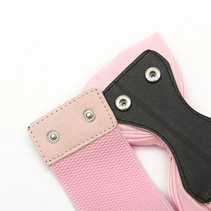 Detail of pink elastic waist belt showing double silver snap buttons and stitch texture