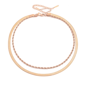 Detail of rose gold double-layered necklace with snake and twisted rope chain styles