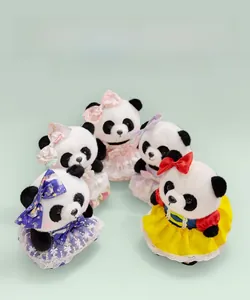 Close-up of adorable panda plush toys in colorful princess dresses and matching bows