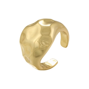 Detail of golden adjustable open ring featuring an irregular hammered metal texture