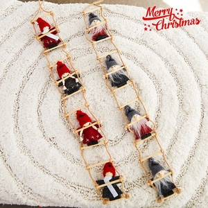 Christmas ladder ornament with cute gnomes in red and grey on white snowy background