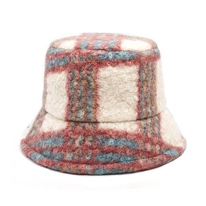 Close-up of thick plaid bucket hat featuring textured warm faux shearling fabric