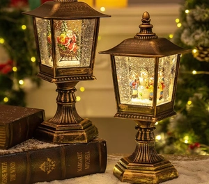 Macro view of vintage bronze Christmas snow globe lanterns with Santa and Snowman scenes