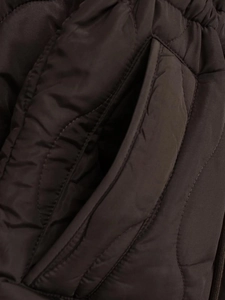 Close-up of wavy quilted texture and side pocket detail on women's dark brown coat