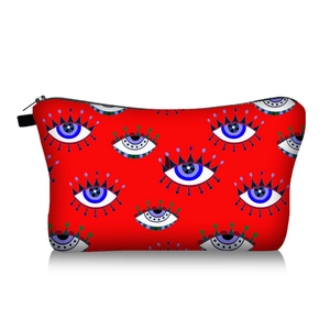 Front view of red cosmetic bag with evil eye pattern and black zipper closure