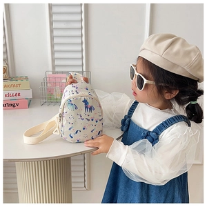 Detailed view of kids unicorn chest bag made of cream canvas with adjustable strap