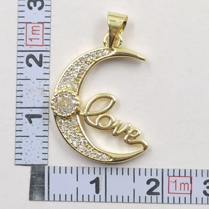 Detailed size measurement of a gold moon pendant with sparkling crystals and Love engraving