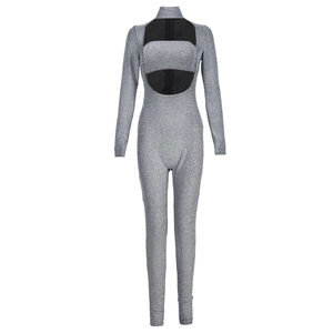 Detail of silver sparkle jumpsuit featuring a turtleneck, cutout bust, and sequined fabric