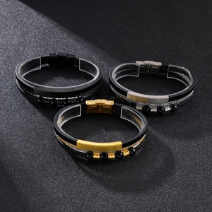 Detail view of multi-layer woven leather bracelets with steel clasps in gold silver and black