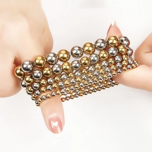 Detail view of mixed gold and silver stainless steel beaded elastic bracelets