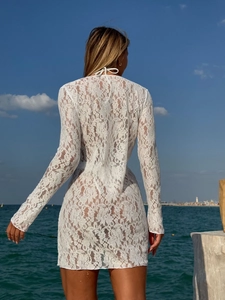 Elegant white lace long-sleeved beach cover-up dress featuring intricate floral hollow patterns