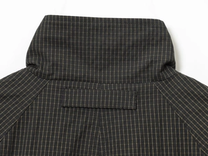 Detail of the high-quality collar stitching and classic micro-check pattern on the jacket