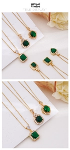 Macro detail of emerald gemstone pendant necklaces with vintage gold crown settings