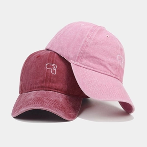 Close-up of vintage washed baseball caps featuring cute dog head embroidery details