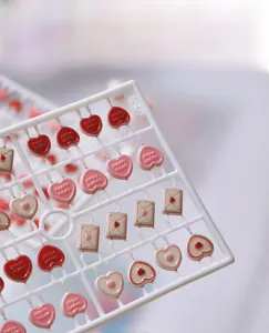 Detailed view of DIY resin heart charms with Sweet Heart relief on injection mold