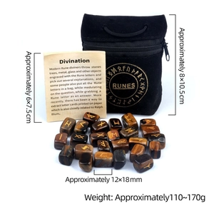 Tiger Eye Rune Stone set with gold engraving, velvet pouch and guidebook on white background