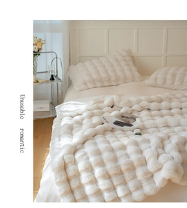 Detail of cream white faux fur blanket featuring a thick luxury 3D wavy texture