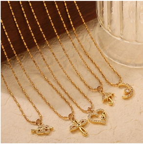 Selection of gold plated titanium steel necklaces with heart, moon, and cross pendants