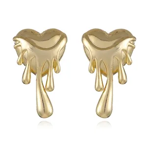 Detail of gold fluid heart earrings featuring a liquid metal melting effect design