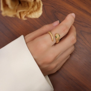Luxurious 18k gold plated titanium steel snake ring with green gem eyes for women