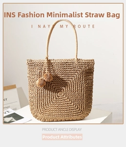Detail of hand-woven straw tote bag showing spiral texture and decorative pom-poms