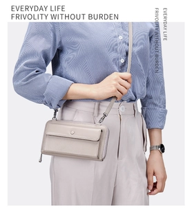 Crossbody phone bag in light grey faux leather with touchscreen window and silver hardware