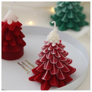Macro detail showing leaf textures on handmade Christmas tree scented candles in gift tray