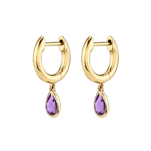 Detail view of gold huggie hoop earrings featuring faceted teardrop purple zircon stones