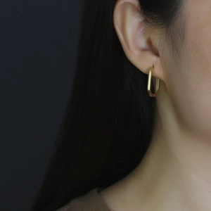 Asian model wearing elegant gold square geometric earrings in polished S925 silver