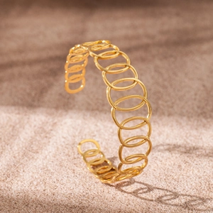 Detailed macro view of 18K gold plated stainless steel hollow C-shaped open bangle