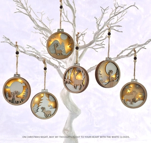Detail of six assorted wooden LED Christmas ornaments featuring deer and forest motifs