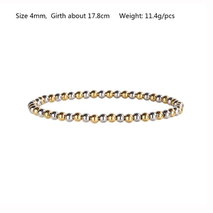 Close-up of a two-tone stretch bracelet with 4mm silver and gold beads on white background