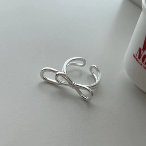 Detail of a minimalist 925 sterling silver bow knot open ring with adjustable band