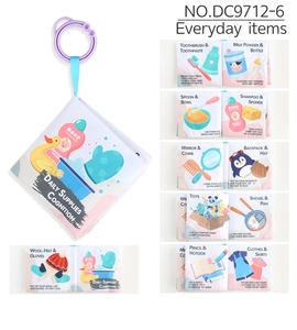 Detail of baby cloth book with purple hanging ring showing daily necessities illustrations