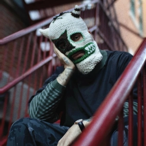 Close-up of handmade crochet balaclava featuring star-shaped eye details and horns