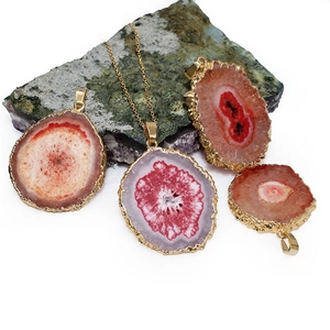 Natural agate sunflower slice pendant with gold plated edges on a fine necklace chain