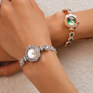 Detail of floral rhinestone bezel watches in silver and gold on model's wrist