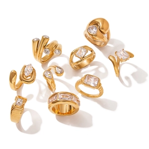 Collection of gold stainless steel rings featuring cubic zirconia and elegant textures