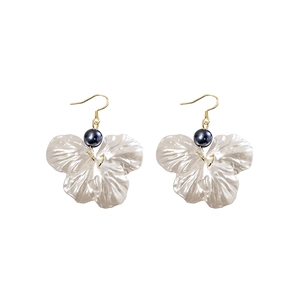 Elegant floral drop earrings with creamy petals and navy pearls on gold hooks
