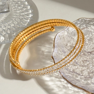 Luxurious gold layered stainless steel bracelet with white zircon stones and spiral design