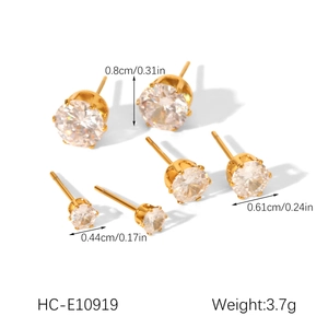 Detailed view of three pairs of gold-plated zircon stud earrings in various sizes