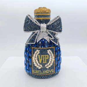 Macro shot of blue crystal wine bottle clutch with VIP rhinestone engraving