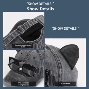 Detail of grey washed denim cat ear baseball cap with removable sunglasses and buckle