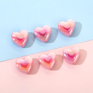 Pink UV plated heart beads for DIY jewelry making on blue and pink background