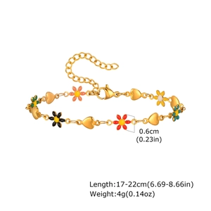 Detail of colorful enamel hearts and flowers on a gold-plated stainless steel bracelet