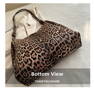 Detail view of large leopard print hobo bag showing bottom construction and knot strap
