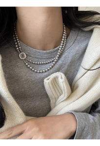 Detail of double-layer grey glass pearl necklace with square mother-of-pearl pendant