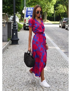 Detail of red and blue floral print dress with V-neck and side slit in street style